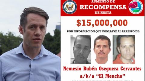 A man in a blue shirt speaking to camera on the left and a red and white wanted poster on the right