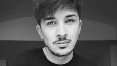 A black and white image of the late Martyn Hett who had dark brown hair and stubble and was wearing a black crew neck top.