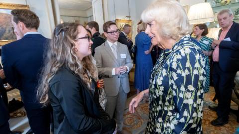 Jessica smiling as she meets the Queen