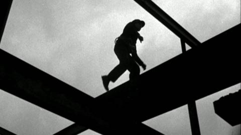 Man walks on scaffolding 