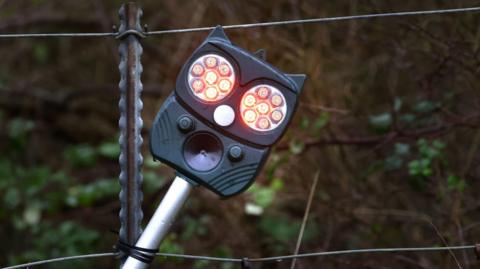 The deer deterrent system, which includes a camera and infra-red technology,  in use next to a wooded area.  