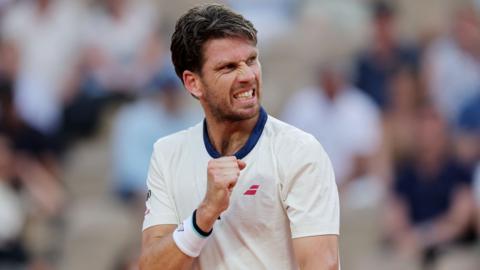 Cameron Norrie pumps his right fist in celebration
