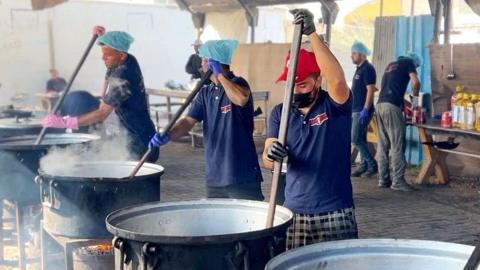 Cooks stir pots of rice and lentils at a community food kitchen run by the US-based humanitarian organisation Anera in Khan Younis, southern Gaza