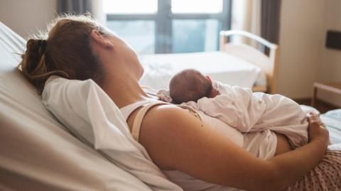 Mother with her newborn baby in the hospital 