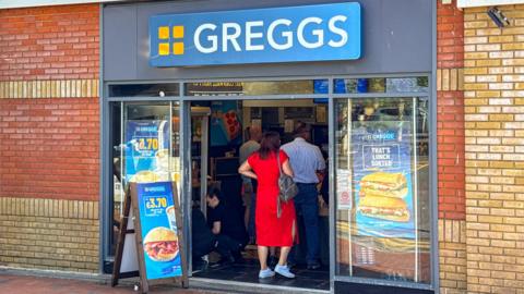 People queuing inside a Greggs