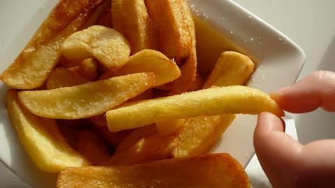 Close-up of a square white plate full of chips