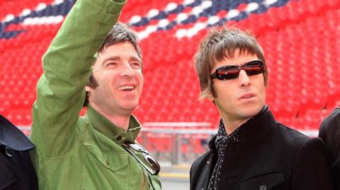 Noel Gallagher and Liam Gallagher of Oasis smiling in 2008