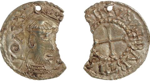 Two views of a gold coin which has a chunk representing perhaps a fifth of its diameter missing out of its side. The left view shows a profile of a man with a beard and tonsure. The right side has a cross in its middle and around it is written St John the Baptist in Latin. John, Baptist and Evangelist