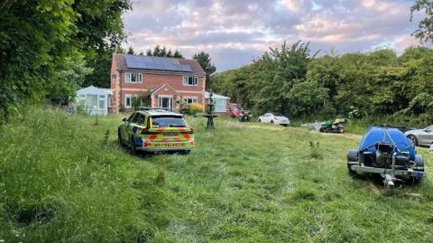 A house with a police car in front