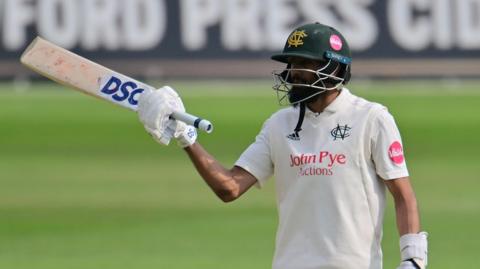 Haseeb Hameed raises his bat for reaching 100