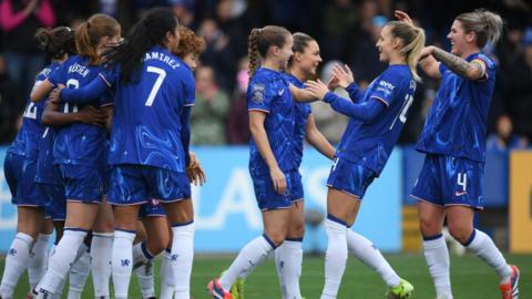 Chelsea players celebrate taking the lead against Manchester United.