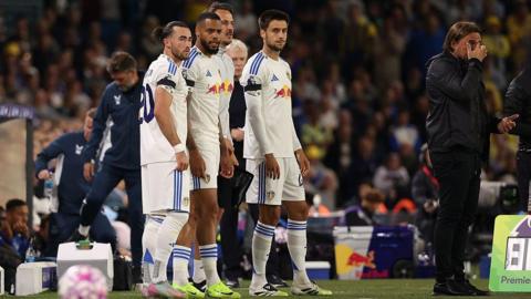 Jack Harrison waits to come on as a substitute with Lukas Nmecha and Ilia Gruev 