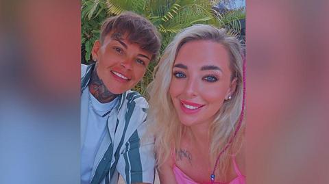 Lauren Campbell (left) with short brown hair wearing a blue striped shirt and blue t-shirt and Laura Pilling with long blond hair wearing a hot pink top. 