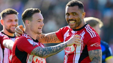 Jayden Wareham and Josh Magennis celebrate