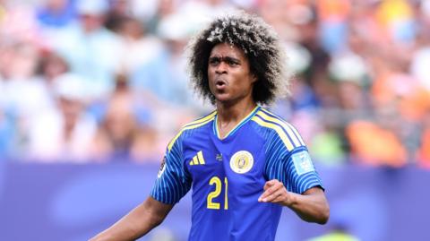 A close-up image of Tahith Chong, wearing his blue and yellow Curacao kit, reacting during their match against Ivory Coast on Thursday