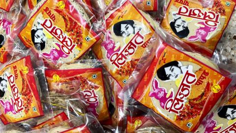 Several packs of Lijjat papad strewn, with its brand name and logo painted on them