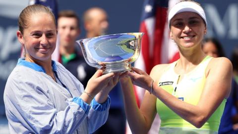 Jelena Ostapenko (left) and Lyudmyla Kichenok with the US Open women's doubles trophy