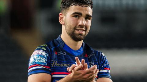 Wakefield Trinity half-back Jack Sinfield applauds the fans after a win at Hull FC