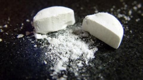 Generic image of a white broken tablet on a black background