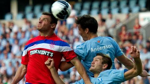 Lee McCulloch battles for the ball with Malmo duo Daniel Andersson and Ivo Pekalski