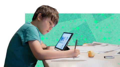 Young boy doing his homework with a laptop