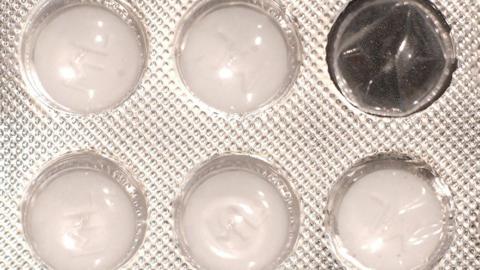 Close up of a blister pack of white tablets with one of the windows empty. The plastic package which features a dimpled, foil wrapper, contains five round tablets.