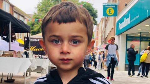 A close up image of Zaahir Jan on a high street looking to camera