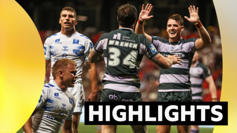 Huddersfield's George Flanagan congratulates Connor Wrench on scoring a try against Toulouse.