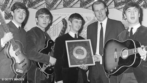 Music producer George Martin with the members of The Beatles.