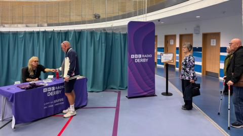 A queue of people registering at the Sun Safe skin check event