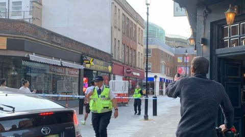 A police cordon is in place and police officers are at the scene of a stabbing on Abington Street in Northamptonshire. 
