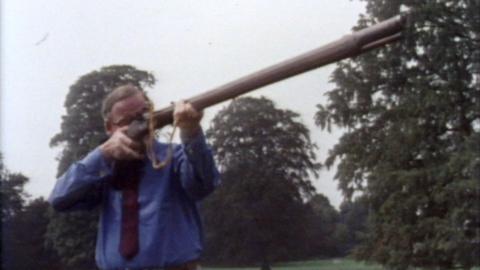 A collector demonstrates how to use an antique gun