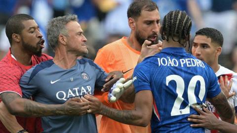 Joao Pedro and Luis Enrique push each other in a confrontation after the Club World Cup final