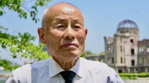 Toshiyuki Mimaki infront of the Hiroshima Peace Memorial building