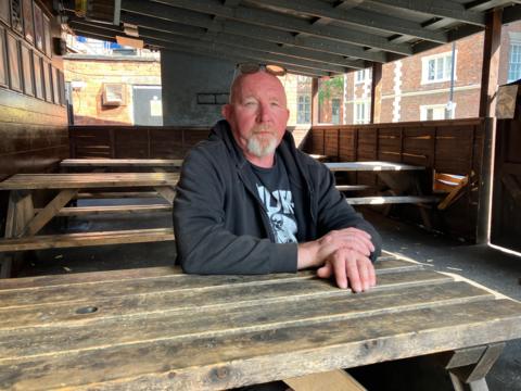 Paul Keenan sat in the outdoor area of the Hairy Dog