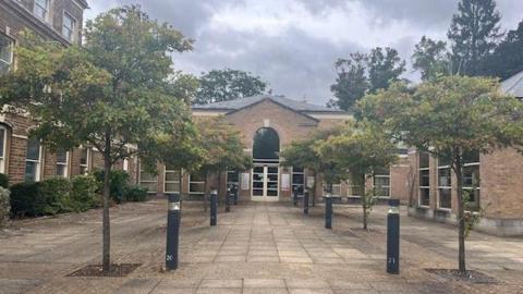 Entrance to Rutland County Council's headquarters with trees lining the route up to the door