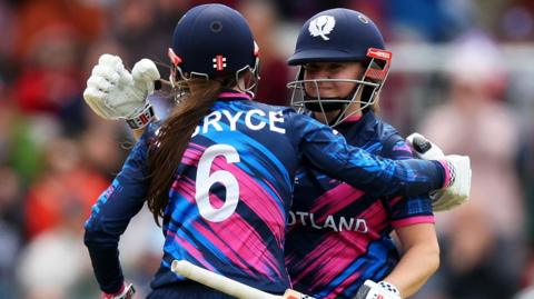 Sarah Bryce congratulates her sister Kathryn on reaching a half-century against Ireland