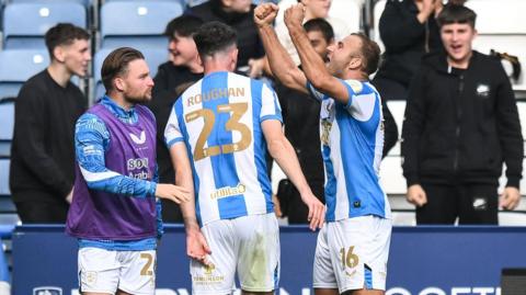 Huddersfield goalscorer Herbie Kane celebrates in front of fans