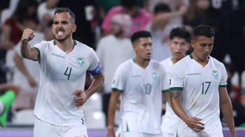 Bolivia celebrate scoring against Iraq