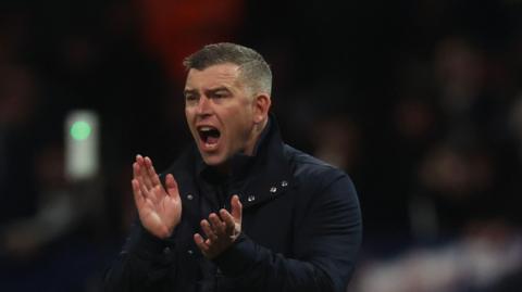 Steven Schumacher applauds his Bolton Wanderers side