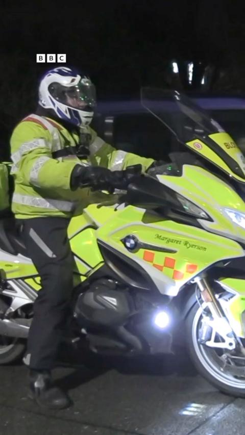 A man in yellow sitting on a motorbike