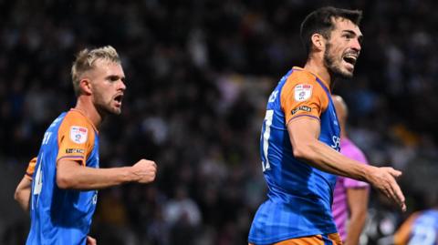 John Marquis (right) celebrates scoring for Shrewsbury 