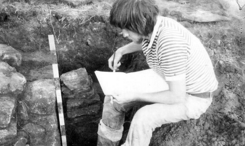 Black and white photo of archaeologist at work