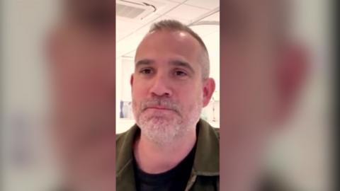Screengrab of Dr Xand, looking into the camera with his mouth closed