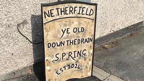 Sign with the inscription Ye Old Down the Drain Spring. Est 2024