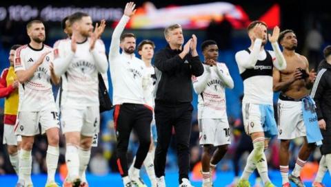 Salford City's players applaud their fans after a 2-0 defeat to Manchester City in the FA Cup