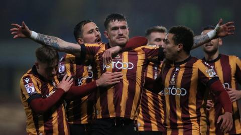 Bradford's Andy Cook holds his arms aloft after scoring against Port Vale