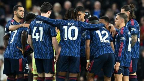Arsenal players in a team huddle before the second half of the Premier League match at Sunderland