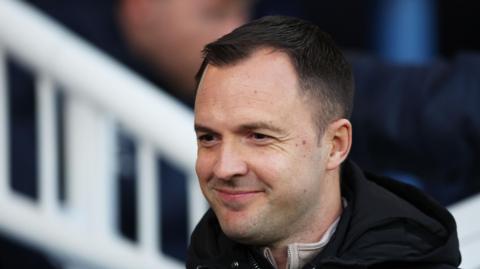 Birmingham City boss Chris Davies smiling on the touchline.