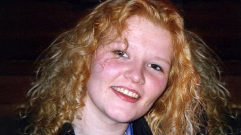 Emma Caldwell smiles for the camera - she has reddish blonde hair.